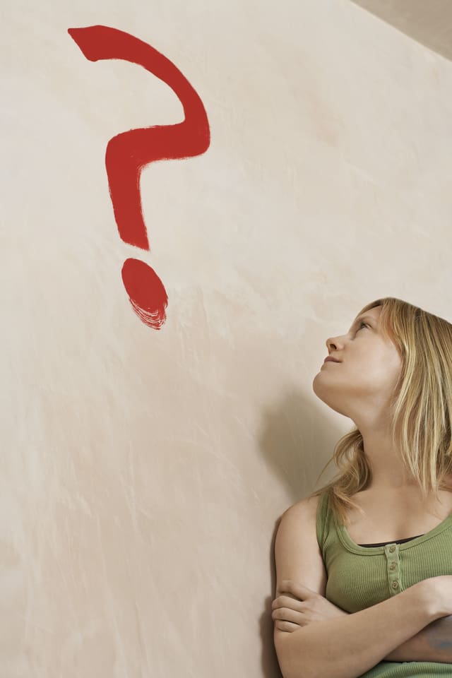 girl looking at question mark on wall...thinking about change 